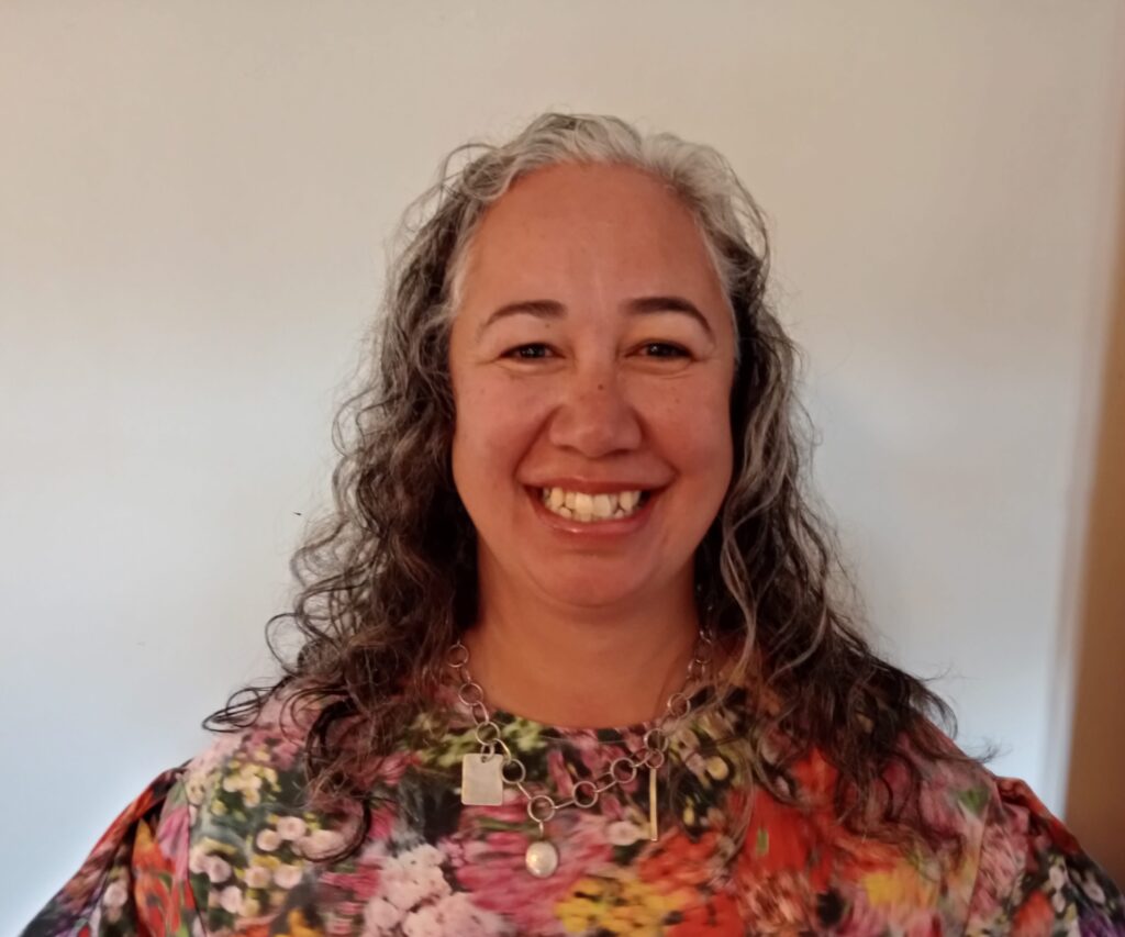 Picture of a smiling woman in a floral top